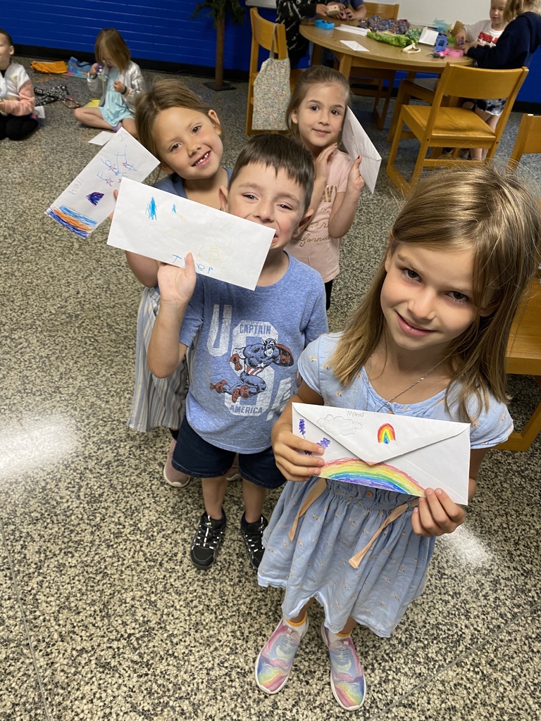Students showing owl buck envelopes
